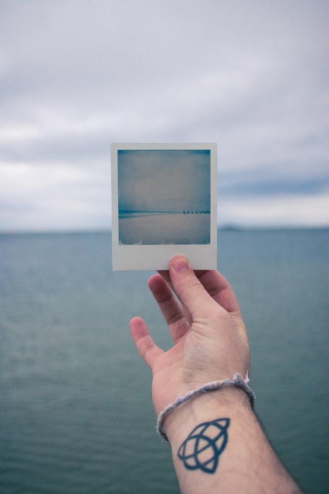 A polaroid photo with the ocean in the background